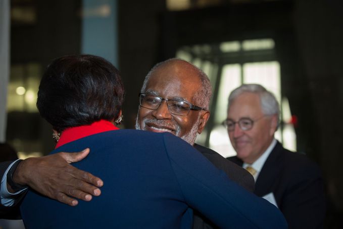 Lisa Davis and Bert Ifill embrace at the Page Center Awards, as past honoree Dick Martin looks on.